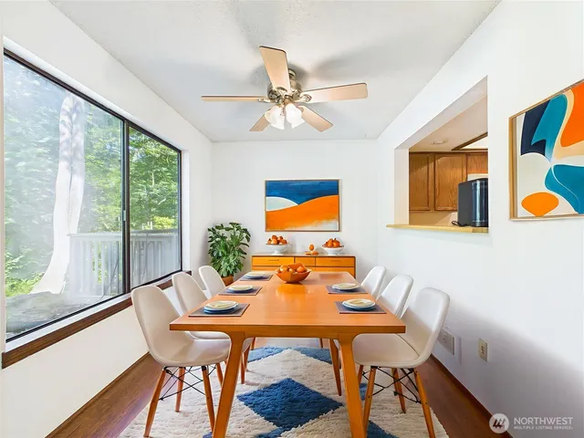 a dining room with furniture and wooden floor