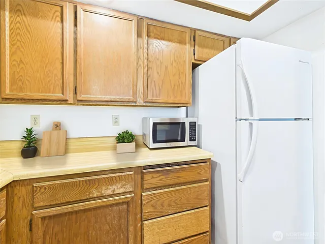 a kitchen with a refrigerator and a sink