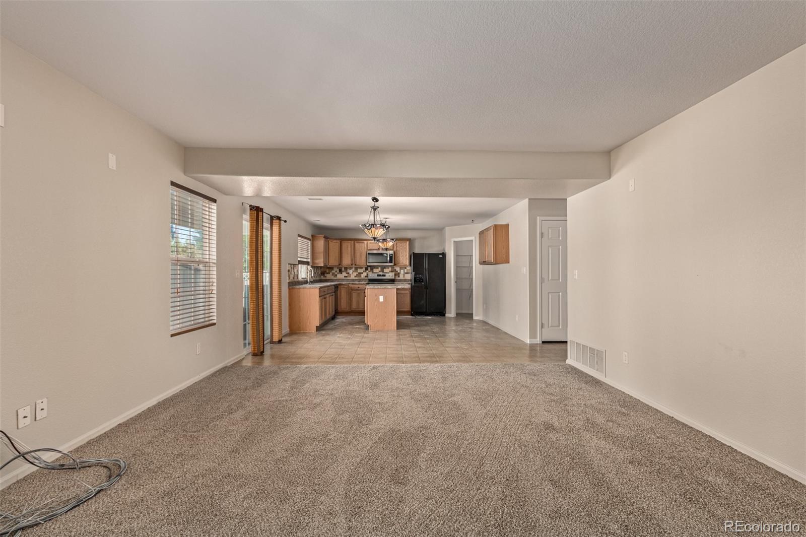 5344 North Perth Street Denver, CO 80249 - Photo 11 of 39 a big room with closet and windows