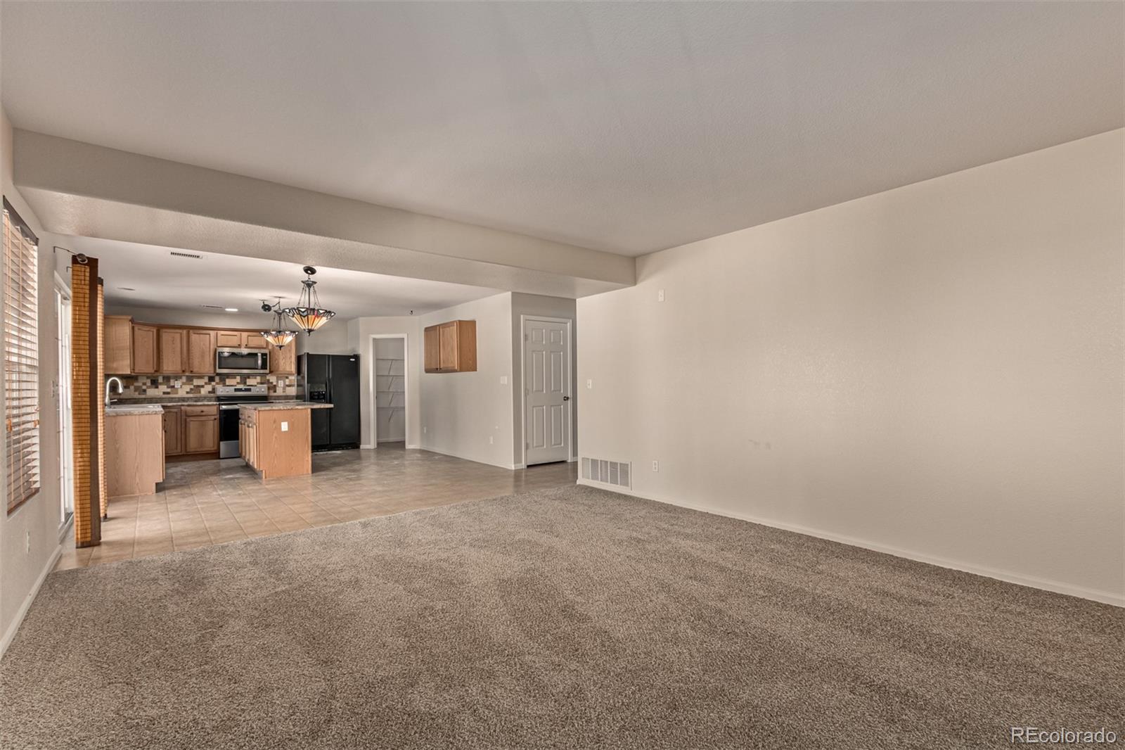 5344 North Perth Street Denver, CO 80249 - Photo 12 of 39 a view of a big room with closet and windows