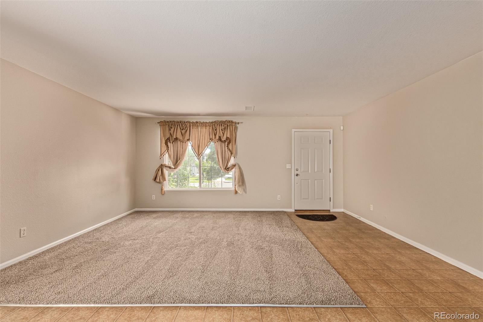 5344 North Perth Street Denver, CO 80249 - Photo 13 of 39 a view of an empty room with wooden floor and window