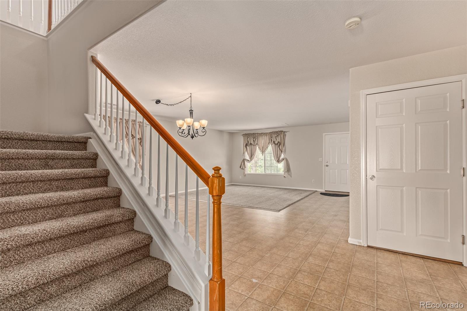 5344 North Perth Street Denver, CO 80249 - Photo 18 of 39 a view of entryway and hall with wooden floor