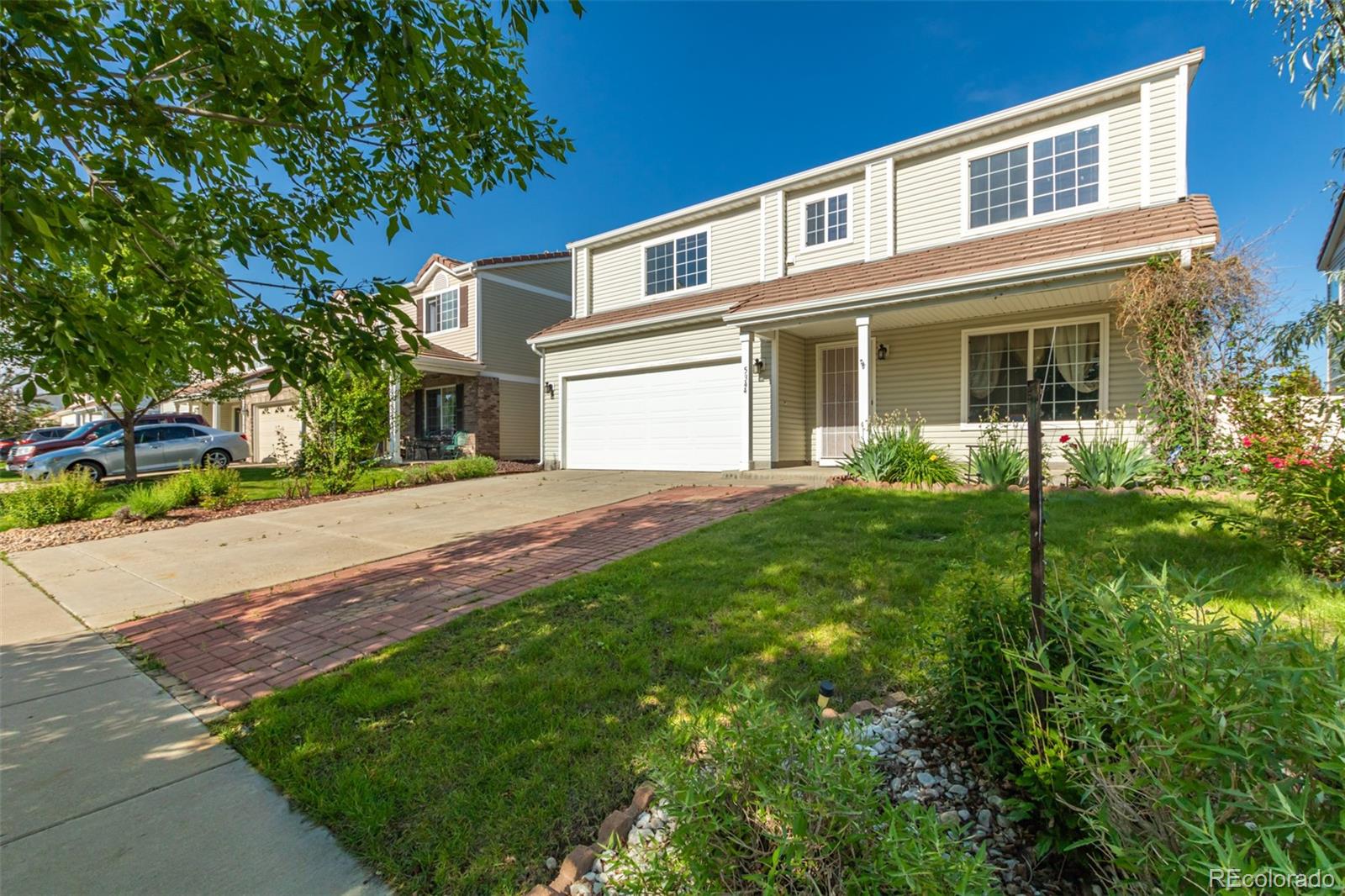 5344 North Perth Street Denver, CO 80249 - Photo 2 of 39 a front view of a house with a yard and trees
