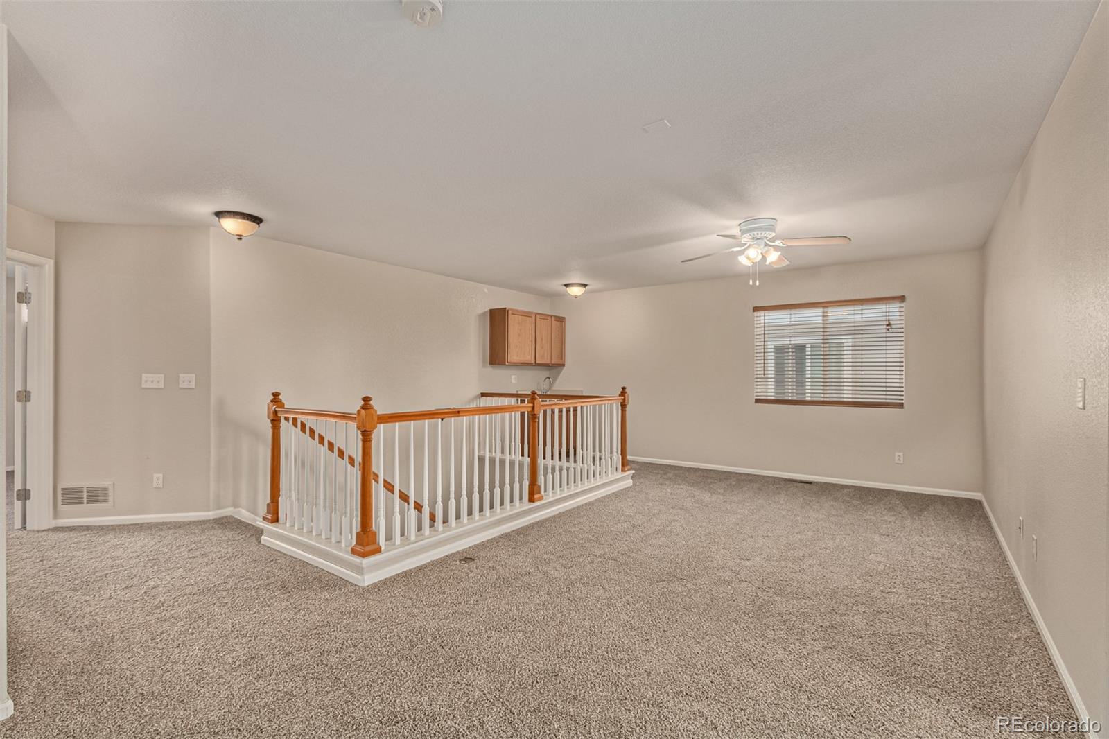 5344 North Perth Street Denver, CO 80249 - Photo 22 of 39 a view of an empty room with windows & cabinet