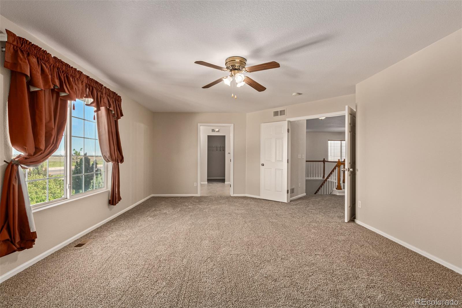 5344 North Perth Street Denver, CO 80249 - Photo 26 of 39 an empty room with windows and fan