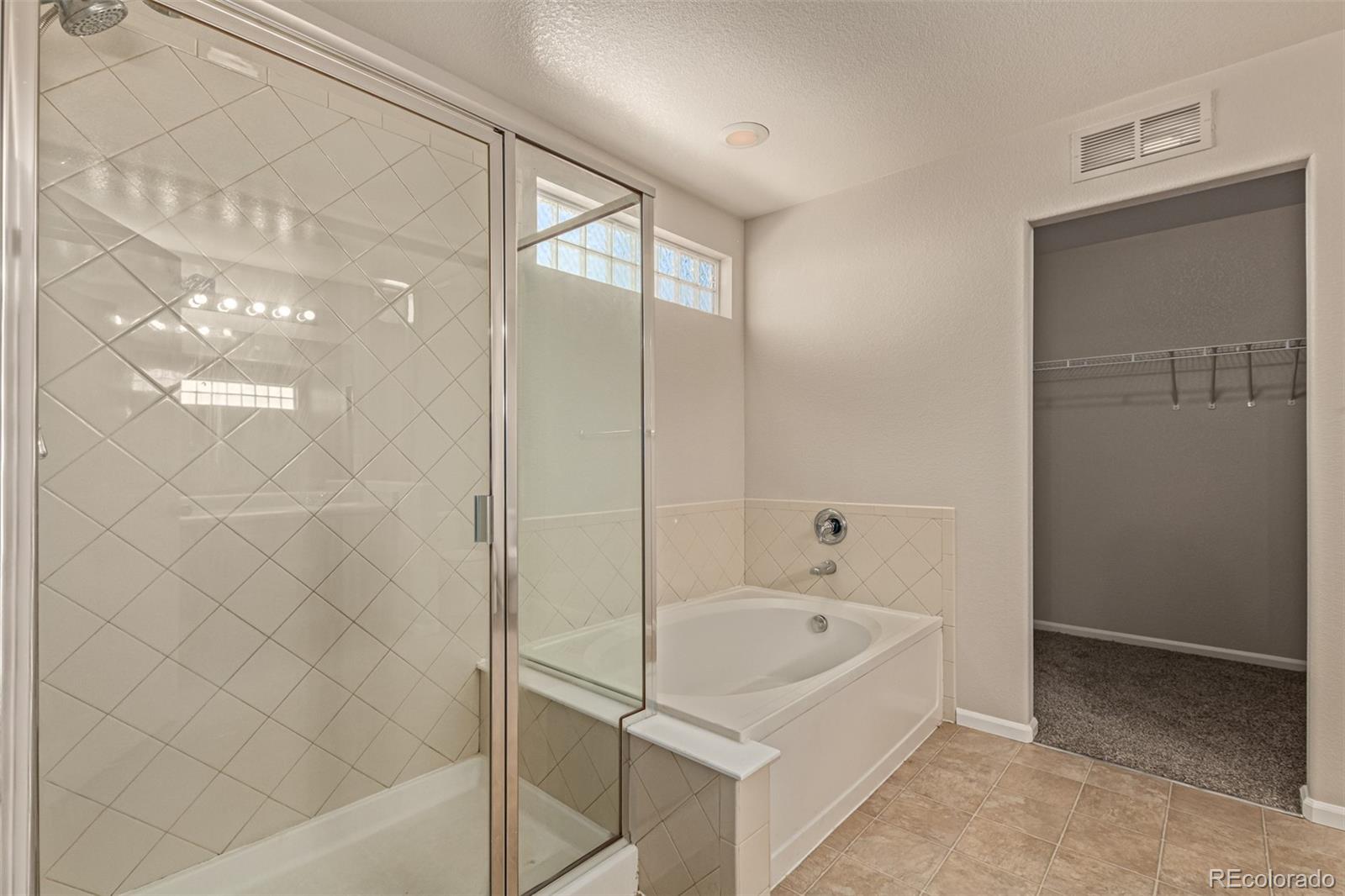5344 North Perth Street Denver, CO 80249 - Photo 29 of 39 a bathroom with a bathtub and shower