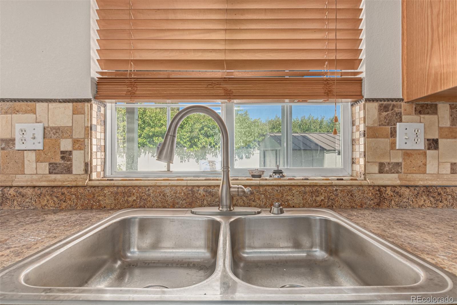 5344 North Perth Street Denver, CO 80249 - Photo 10 of 39 a kitchen sink sitting next to a window
