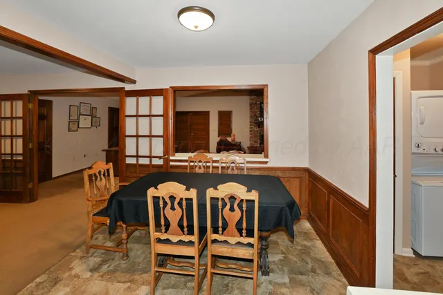a view of a dining room with furniture and chandelier