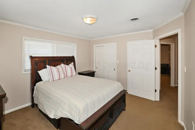 a bed room with a bed and a night stand