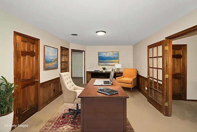 a living room with furniture a window and a flat screen tv