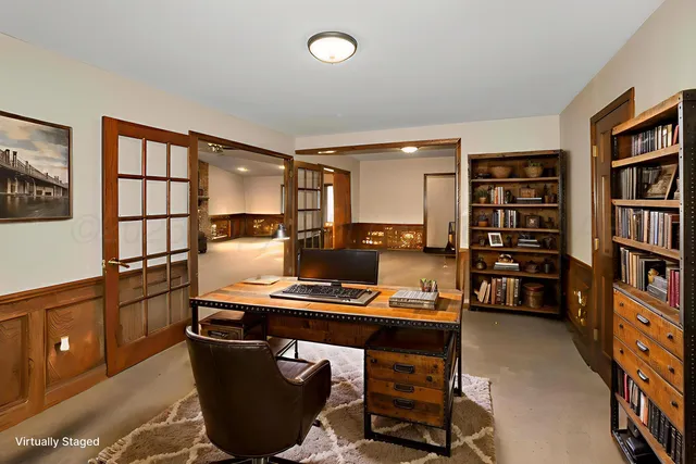 a room with furniture a bookshelf and a window