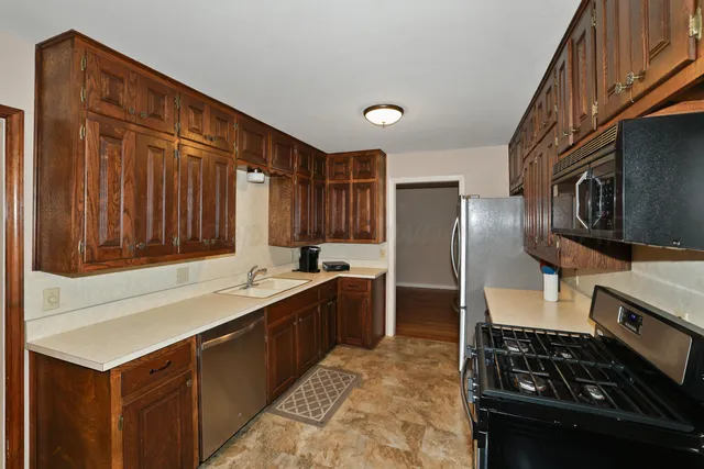 a kitchen with a sink stove and refrigerator