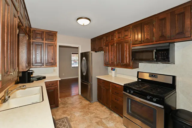 a kitchen with stainless steel appliances a stove a sink and a refrigerator