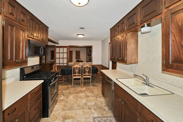 a kitchen with a sink stove and cabinets