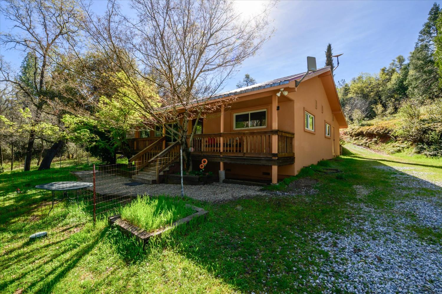 3640 Omo Ranch Road Somerset, CA 95684 - Photo 3 of 57 a view of a backyard with a large tree