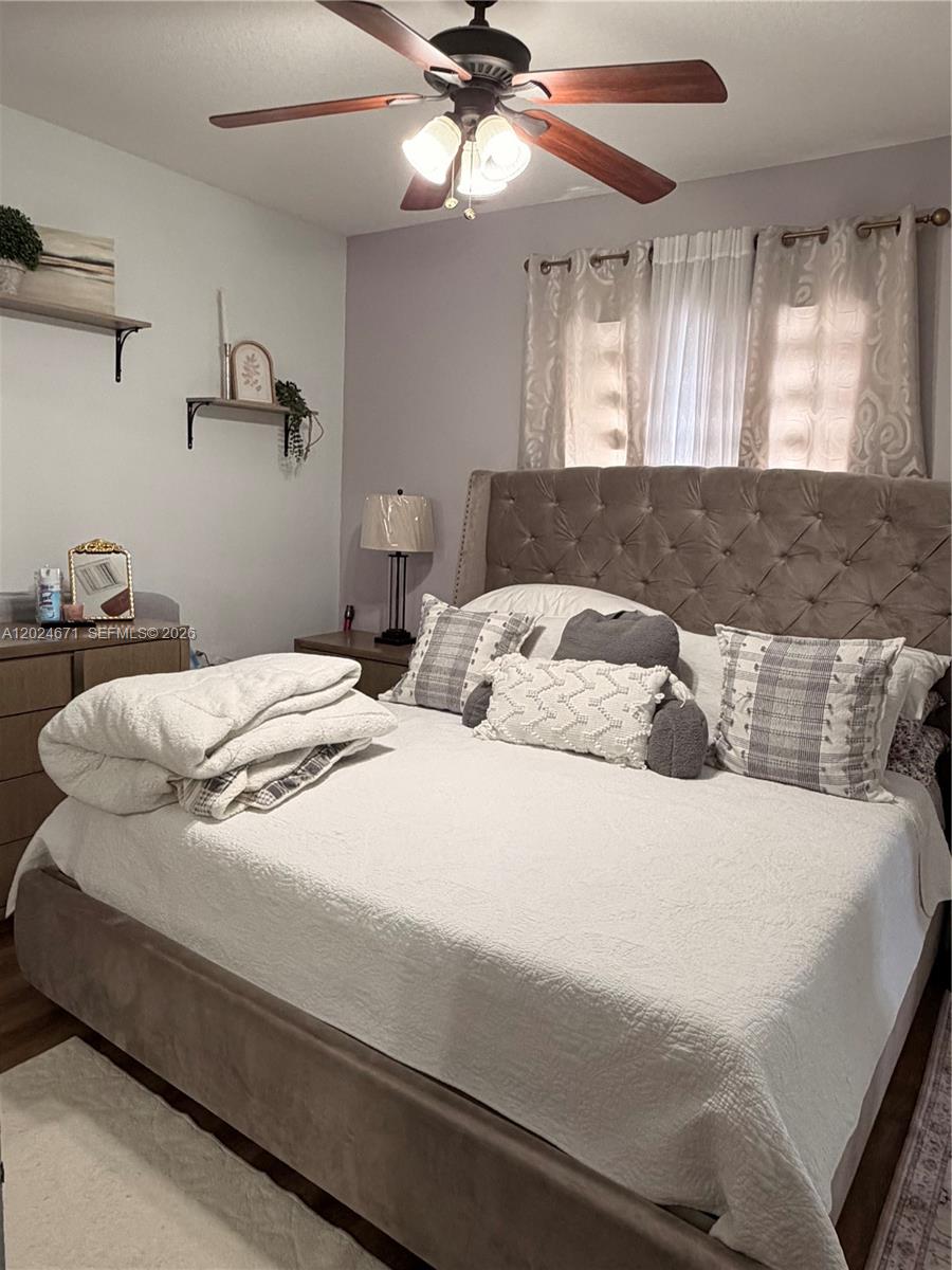 2116 Northeast 38th Road, Unit 2116 Homestead, FL 33033 - Photo 20 of 31 a bedroom with a bed and window