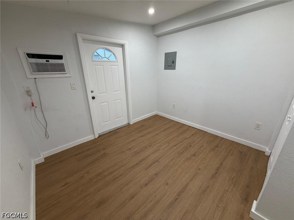 a view of empty room with wooden floor