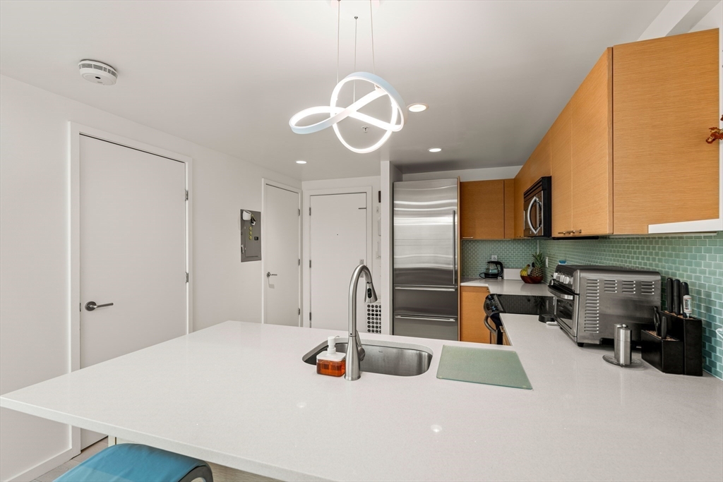 1 Earhart Street, Unit 705 Cambridge, MA 02141 - Photo 12 of 38 a kitchen with a table and chairs in it