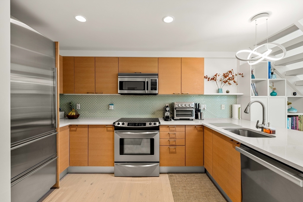 1 Earhart Street, Unit 705 Cambridge, MA 02141 - Photo 13 of 38 a kitchen with a sink stove and microwave