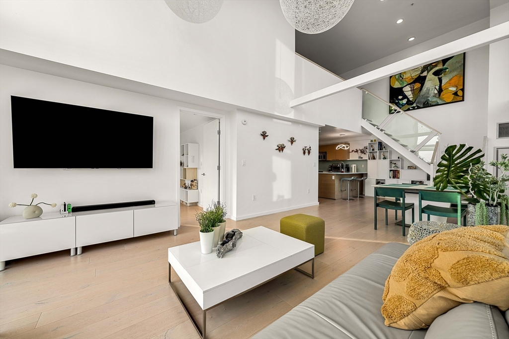 1 Earhart Street, Unit 705 Cambridge, MA 02141 - Photo 15 of 38 a living room with furniture and a flat screen tv