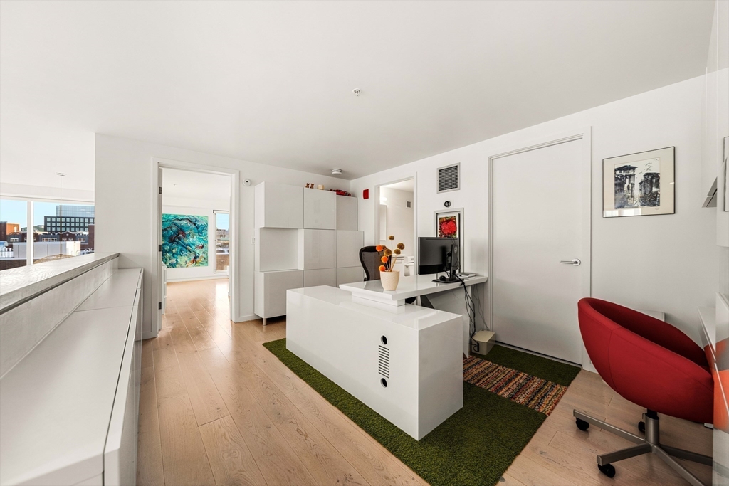 1 Earhart Street, Unit 705 Cambridge, MA 02141 - Photo 18 of 38 a view of a kitchen with furniture and a workspace