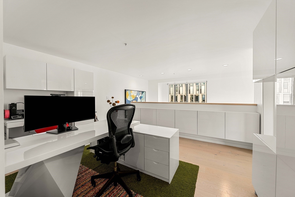 1 Earhart Street, Unit 705 Cambridge, MA 02141 - Photo 20 of 38 a view of a workspace with furniture and wooden floor
