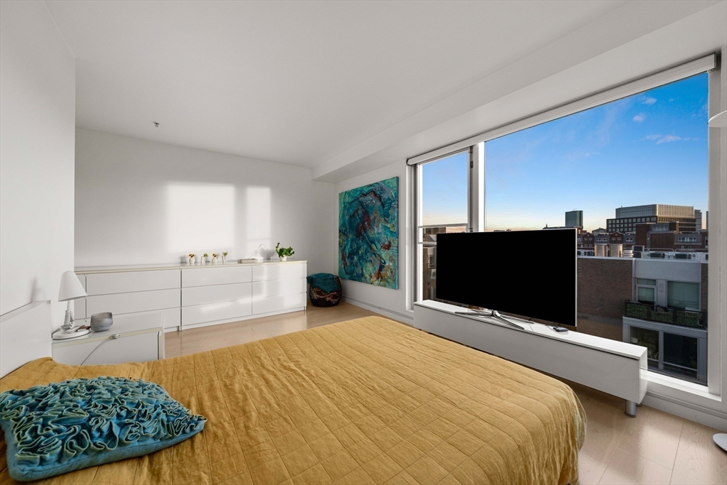1 Earhart Street, Unit 705 Cambridge, MA 02141 - Photo 25 of 38 a bedroom with a bed and a flat screen tv