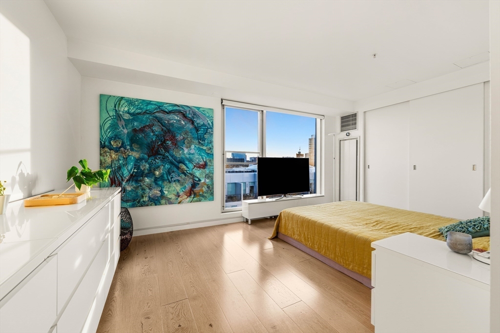 1 Earhart Street, Unit 705 Cambridge, MA 02141 - Photo 26 of 38 a bedroom with a bed and a flat screen tv