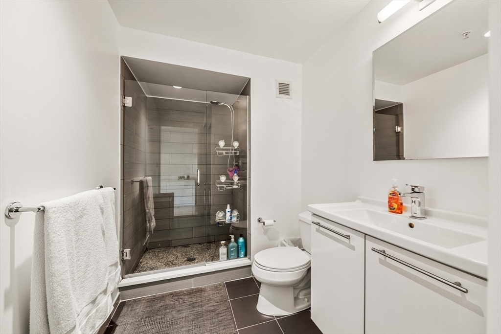 1 Earhart Street, Unit 705 Cambridge, MA 02141 - Photo 29 of 38 a bathroom with a sink toilet and shower