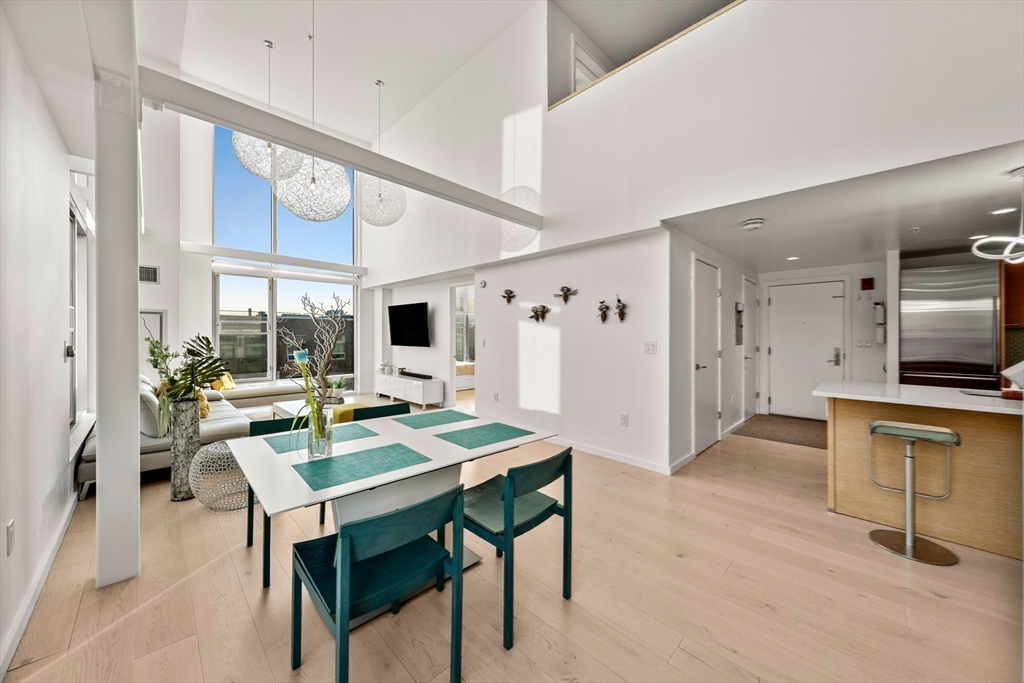 1 Earhart Street, Unit 705 Cambridge, MA 02141 - Photo 32 of 38 a view of a dining room with furniture window and wooden floor
