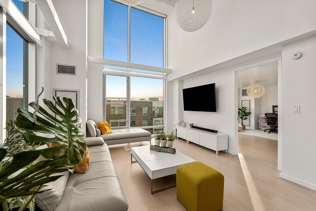 1 Earhart Street, Unit 705 Cambridge, MA 02141 - Photo 34 of 38 a living room with furniture and a flat screen tv