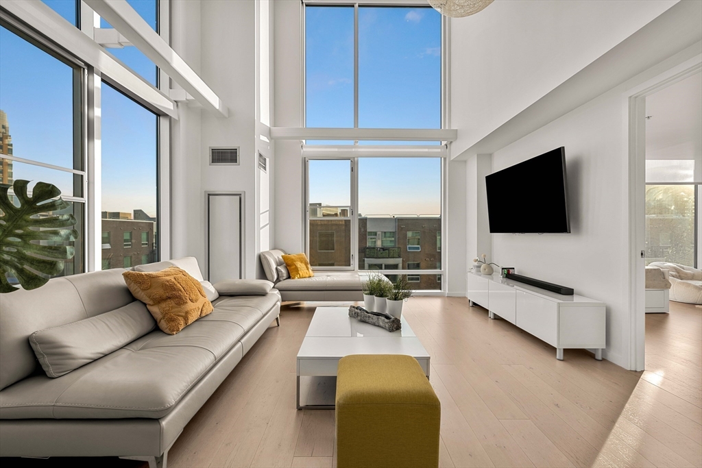 1 Earhart Street, Unit 705 Cambridge, MA 02141 - Photo 35 of 38 a living room with furniture and a flat screen tv