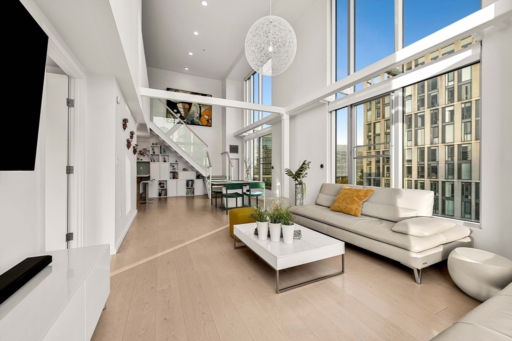 1 Earhart Street, Unit 705 Cambridge, MA 02141 - Photo 36 of 38 a living room with furniture and a large window