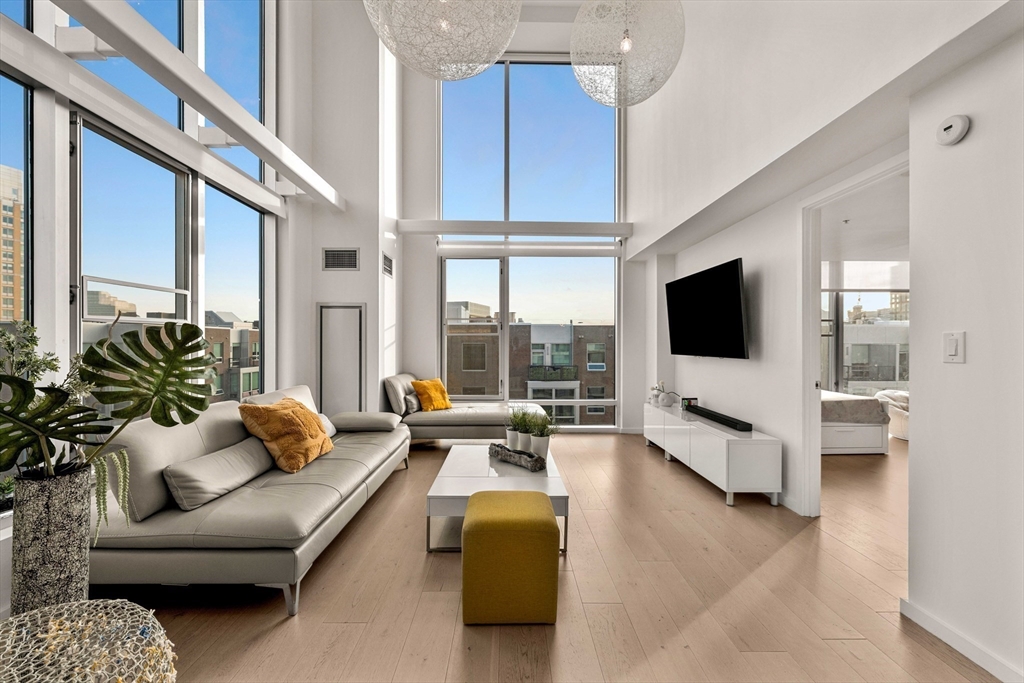 1 Earhart Street, Unit 705 Cambridge, MA 02141 - Photo 4 of 38 a living room with furniture and a flat screen tv