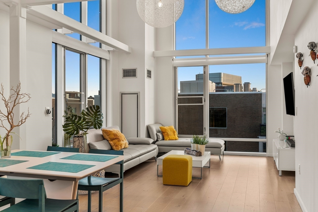 1 Earhart Street, Unit 705 Cambridge, MA 02141 - Photo 6 of 38 a living room with furniture and a flat screen tv