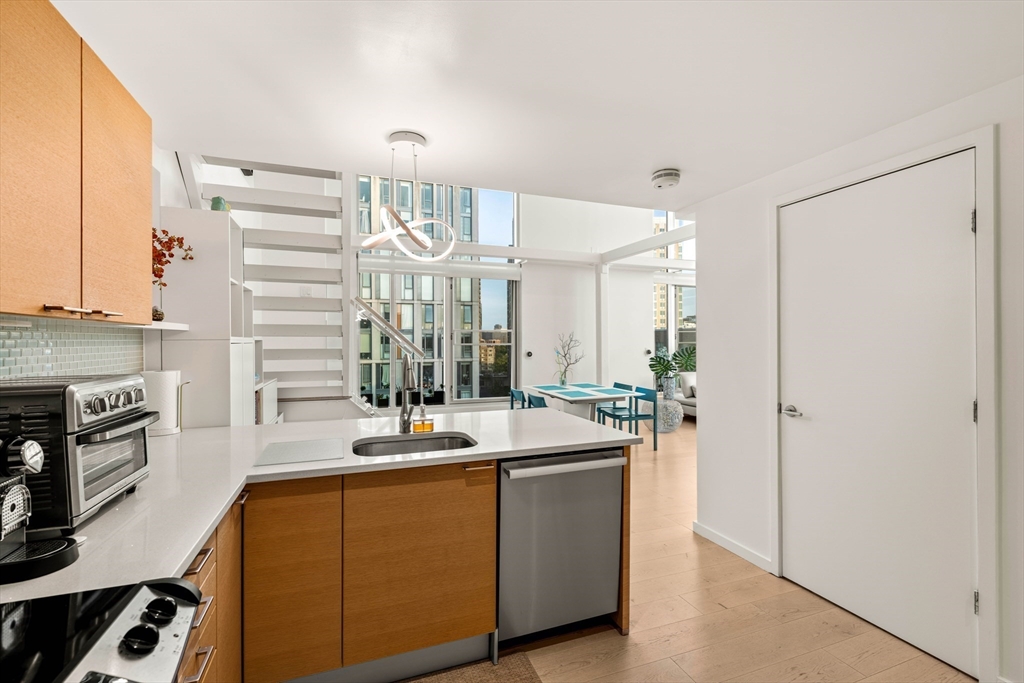 1 Earhart Street, Unit 705 Cambridge, MA 02141 - Photo 9 of 38 a kitchen with a sink appliances and cabinets