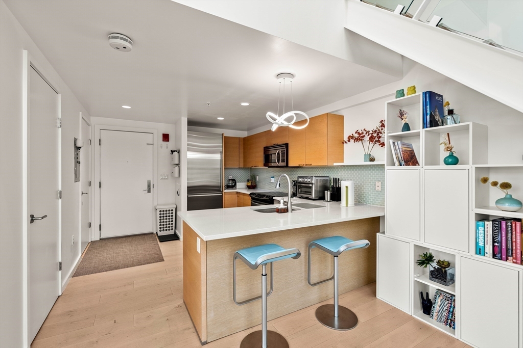 1 Earhart Street, Unit 705 Cambridge, MA 02141 - Photo 10 of 38 a large white kitchen with lots of counter space and refrigerator