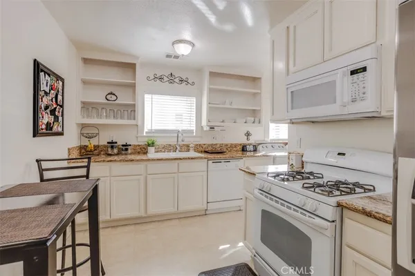 a kitchen with cabinets appliances and a window