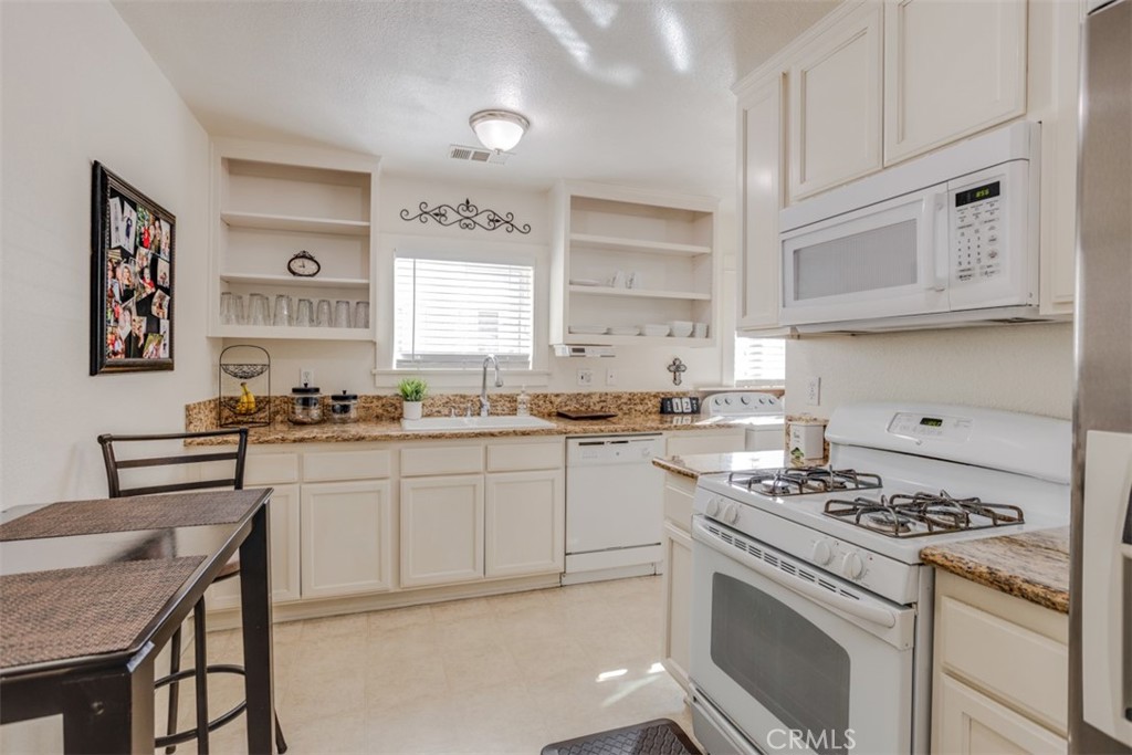 15461 Hesperia Road Victorville, CA 92395 - Photo 12 of 28 a kitchen with cabinets appliances and a window