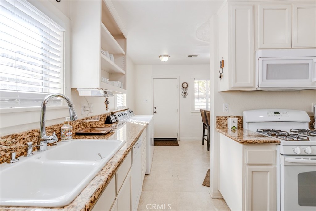 15461 Hesperia Road Victorville, CA 92395 - Photo 14 of 28 a kitchen with stainless steel appliances a sink stove and cabinets