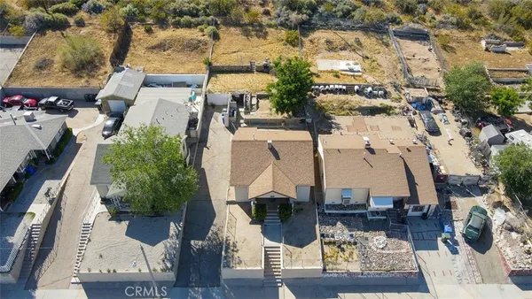 an aerial view of a house with outdoor space