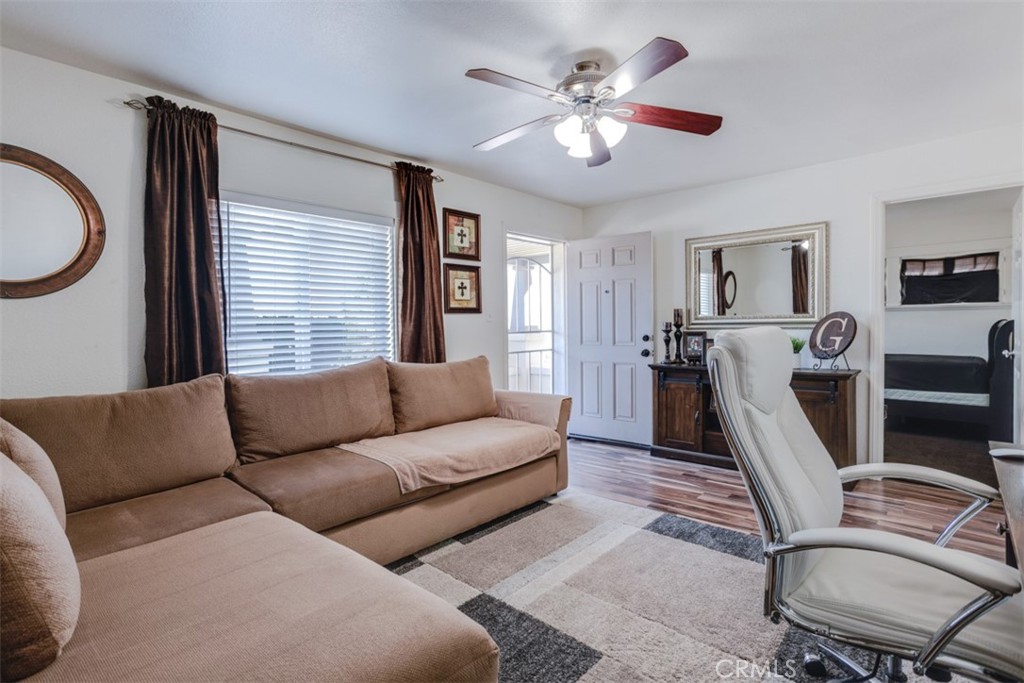 15461 Hesperia Road Victorville, CA 92395 - Photo 5 of 28 a living room with furniture a large window and a chandelier