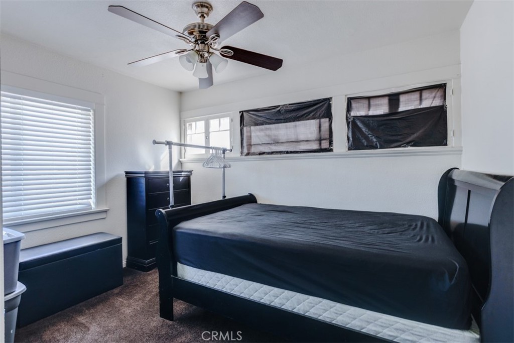 15461 Hesperia Road Victorville, CA 92395 - Photo 6 of 28 a bedroom with a bed and a table
