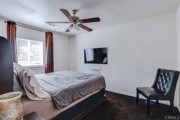 a bedroom with a bed and a chair