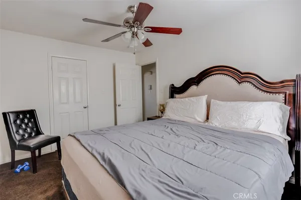 a bedroom with a bed and a chair