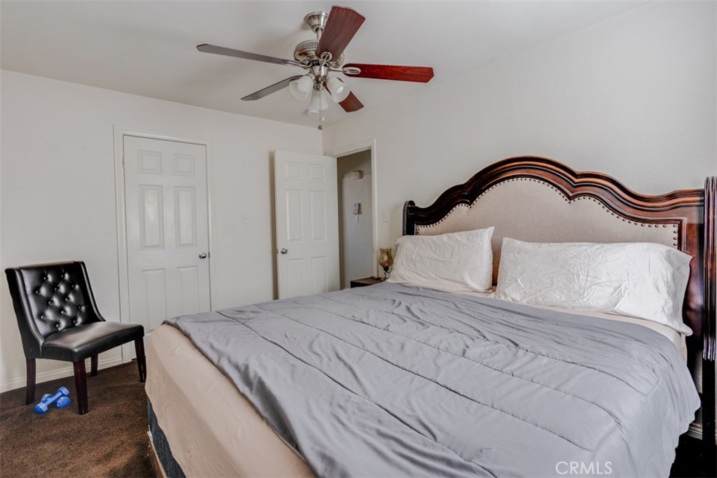15461 Hesperia Road Victorville, CA 92395 - Photo 9 of 28 a bedroom with a bed and a chair