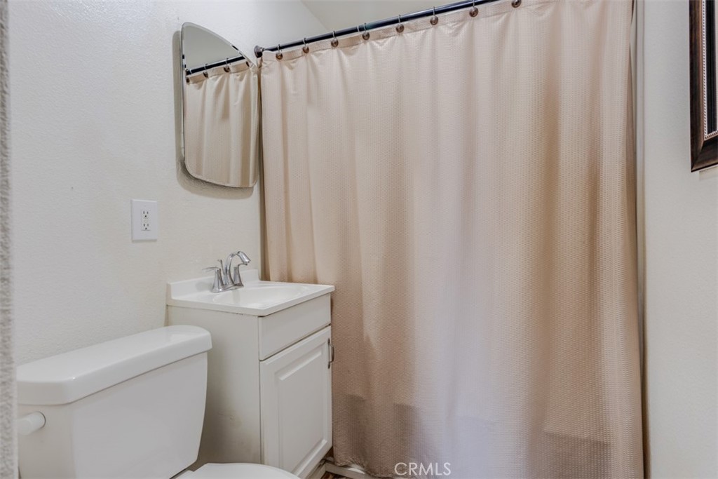 15461 Hesperia Road Victorville, CA 92395 - Photo 10 of 28 a bathroom with a sink and a mirror
