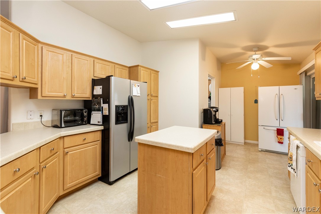 4102 Cibola Road Golden Valley, AZ 86413 - Photo 14 of 71 a kitchen with a refrigerator a sink dishwasher and a refrigerator with wooden floor