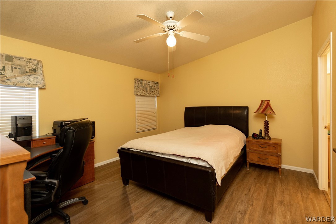4102 Cibola Road Golden Valley, AZ 86413 - Photo 22 of 71 a bedroom with a bed and a chair with the potted plant