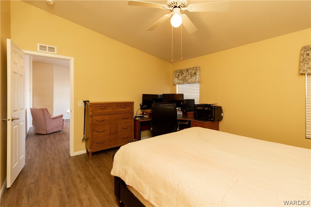 4102 Cibola Road Golden Valley, AZ 86413 - Photo 23 of 71 a bedroom with a bed and a chandelier